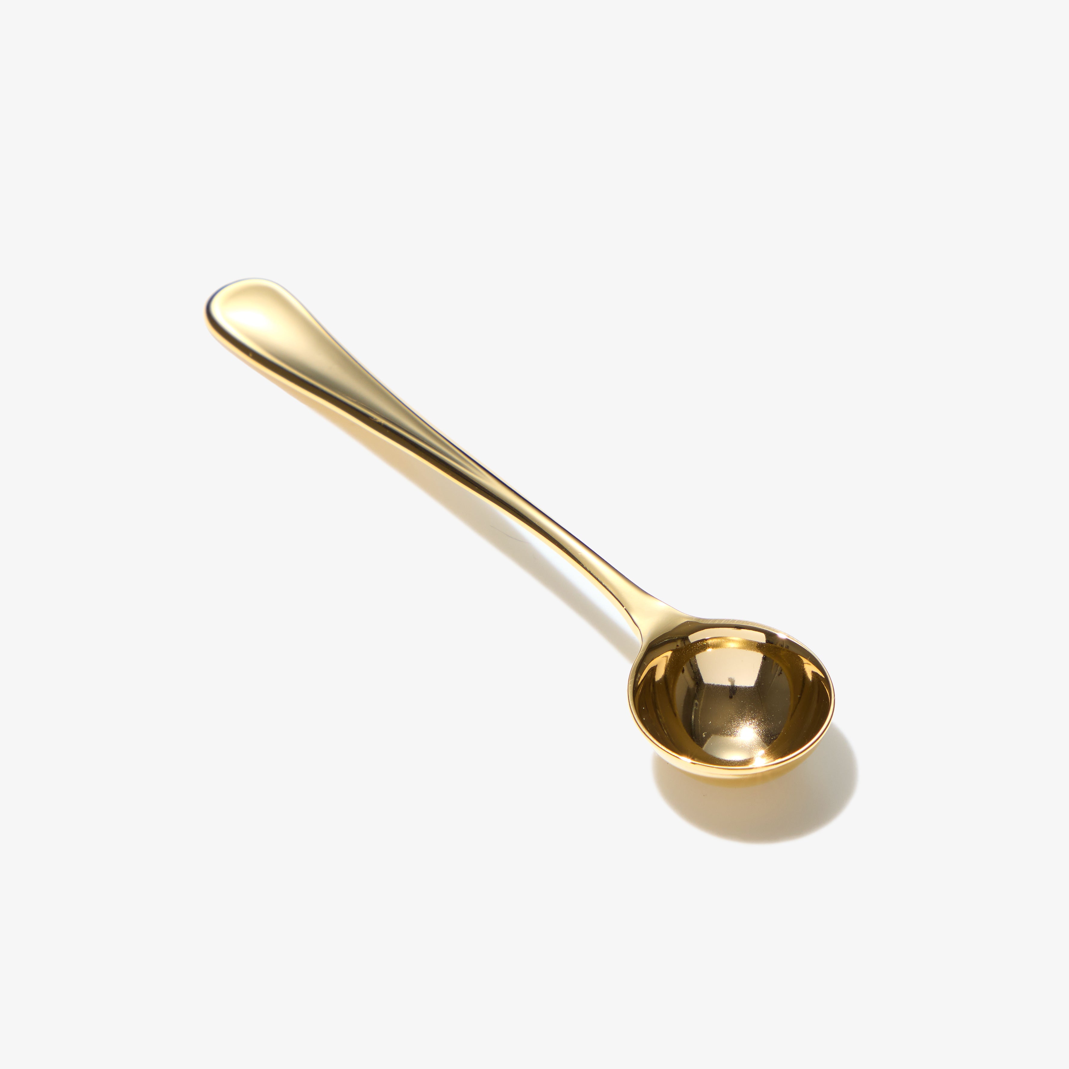 Gold matcha scoop on white background