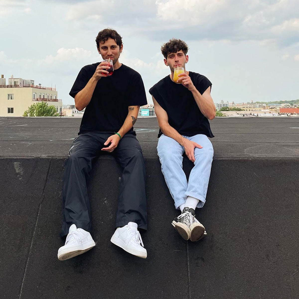 Two founders of Swheat Straws sitting on top of a roof
